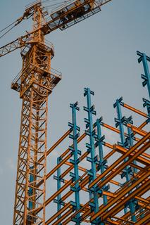 A construction crane with some steel beams.